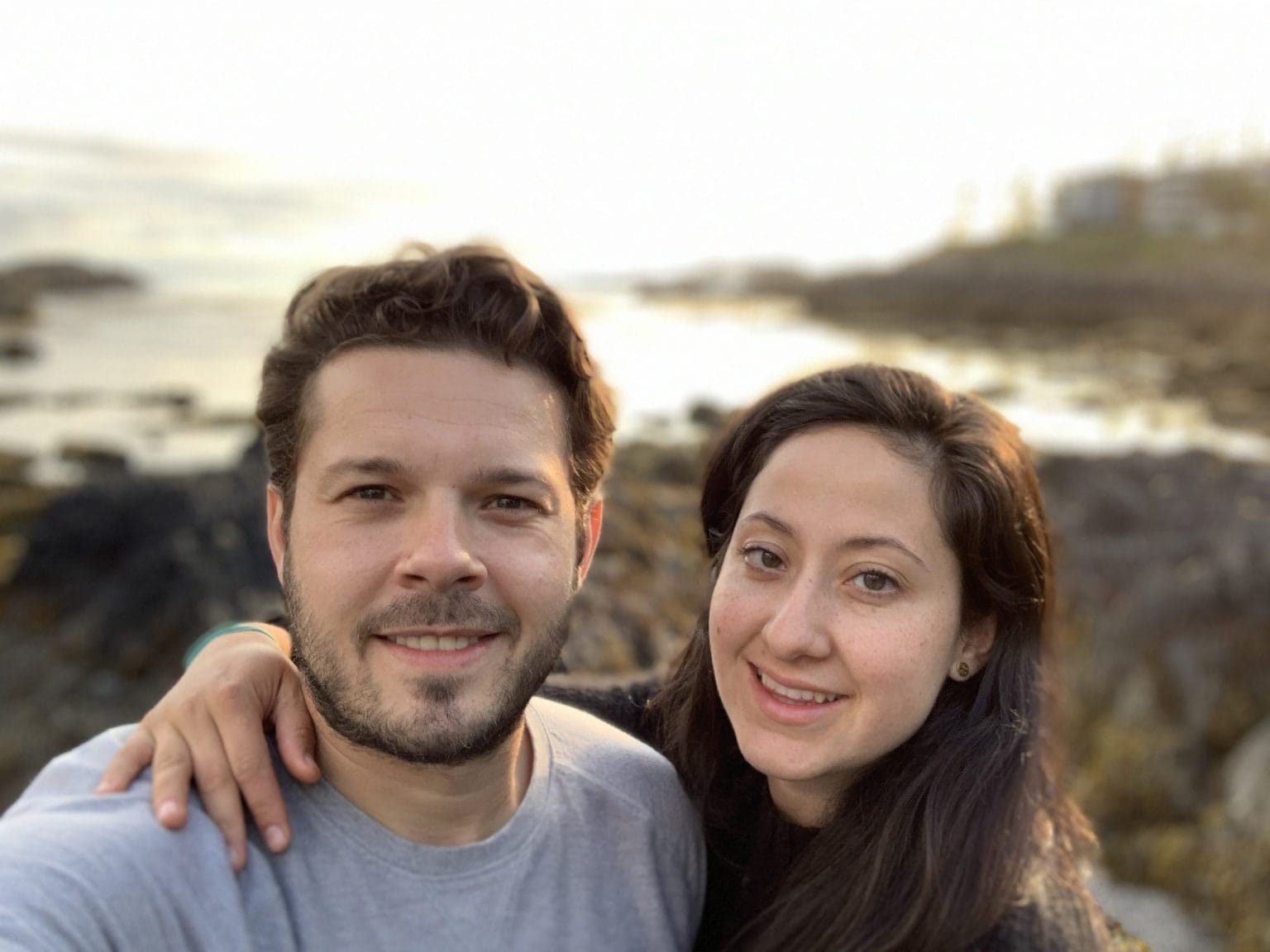 Anthony Wingham and a woman smile at the camera. The woman has her arm around Anthony's shoulder.