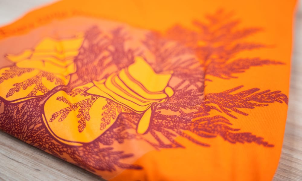 Orange shirt with design on it
