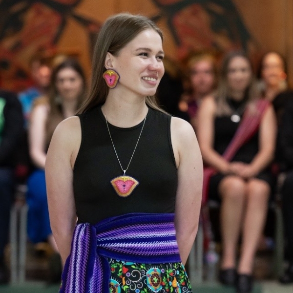 Image of a young woman with a sash around her waist.