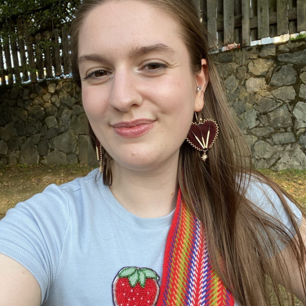 Selfie image of a young woman with a Metis sash over her shoulder.
