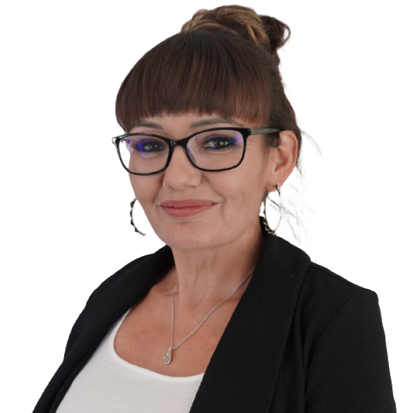 Dawna Short is smiling in a black blazer and white shirt against a neutral background.