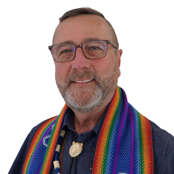 Rob Anderson is smiling in a blue formal shirt with a rainbow Métis sash draped over their shoulders against a white background.
